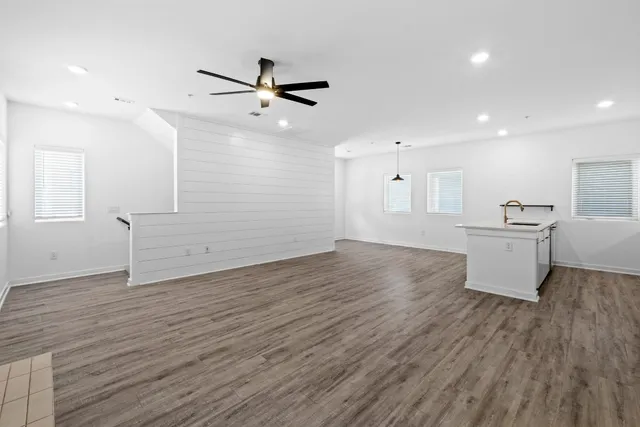 a view of a kitchen with wooden floor and a sink