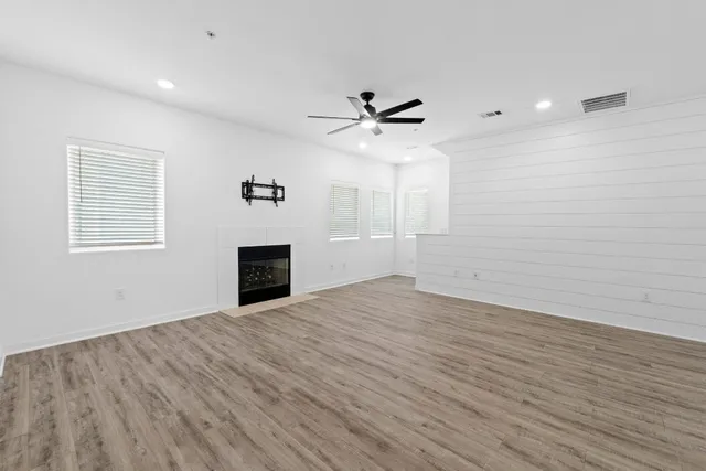 wooden floor in an empty room with a window