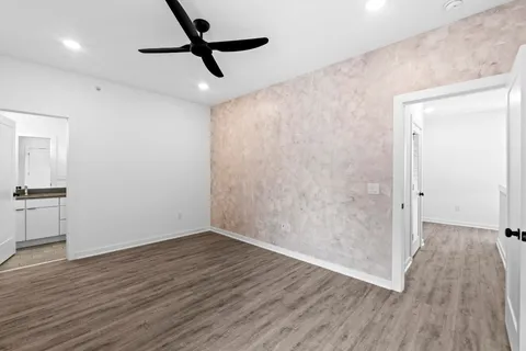 a view of empty room with wooden floor