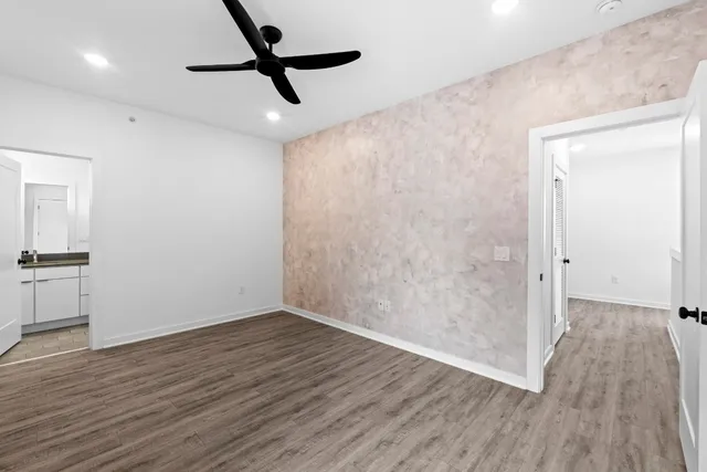 a view of empty room with wooden floor