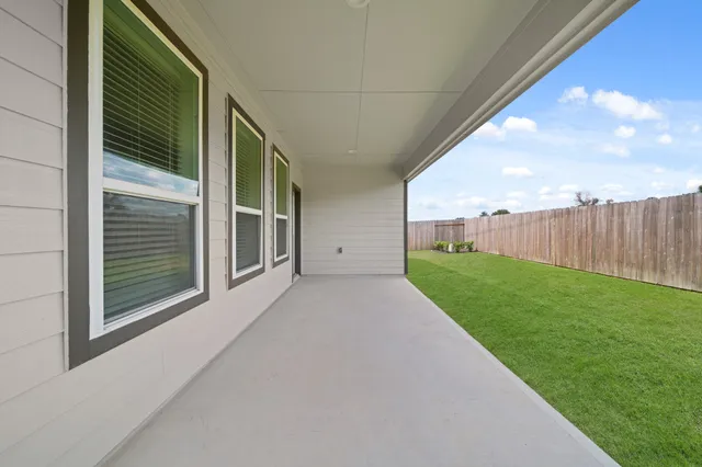 front view of a brick house with a yard