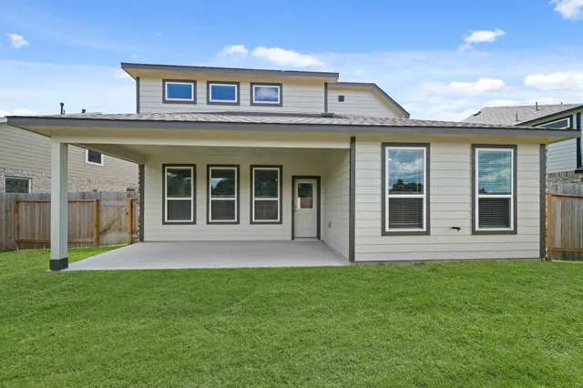 a view of a house with a yard and deck