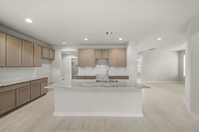 a large kitchen with stainless steel appliances lots of counter top space