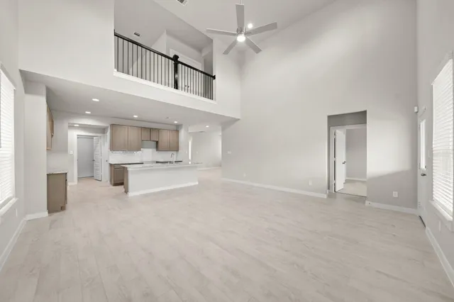 a view of an empty room with a kitchen