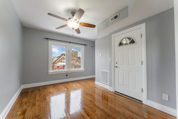 1215 North Harding Avenue, Unit 2 Chicago, IL 60651 - Photo 2 of 10 a view of an empty room with window and wooden floor