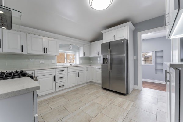 1215 North Harding Avenue, Unit 2 Chicago, IL 60651 - Photo 8 of 10 a kitchen with stainless steel appliances granite countertop a refrigerator and a stove top oven