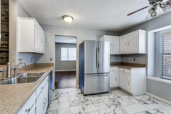 a kitchen with stainless steel appliances granite countertop a refrigerator sink and cabinets