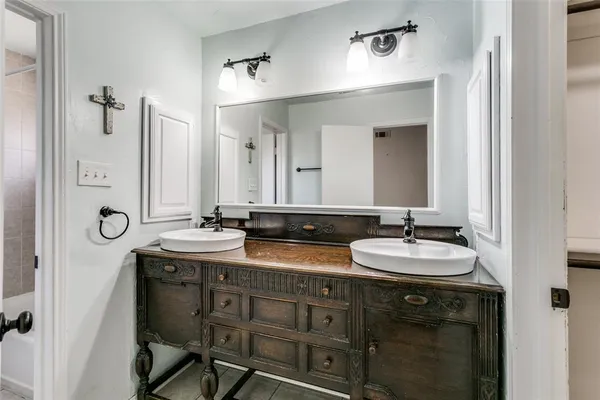 a bathroom with double vanity sinks and a mirror