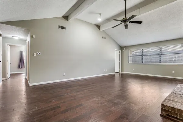 a view of a livingroom with wooden floor and a ceiling fan