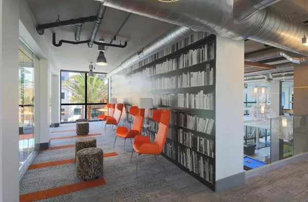 a living room with lots of furniture and a book shelf