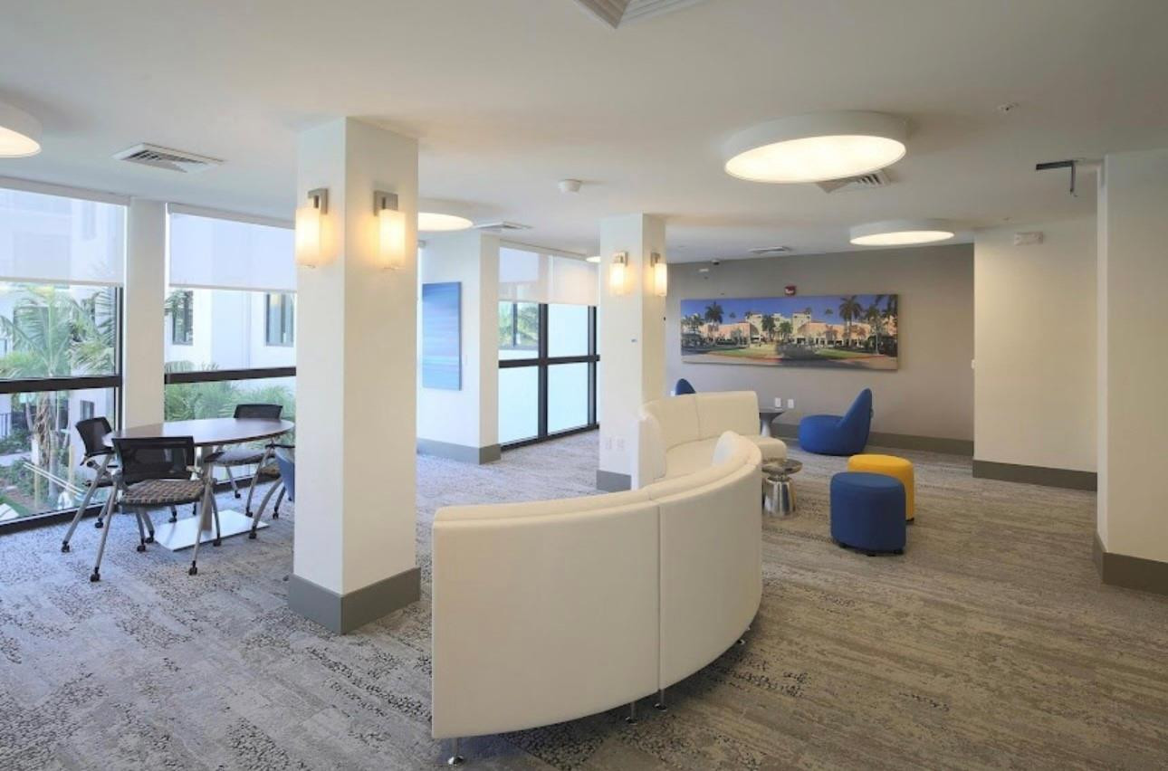 135 Northwest 20th Street, Unit E45B Boca Raton, FL 33431 - Photo 20 of 21 a living room with furniture and a large window