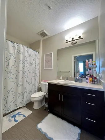 a spacious bathroom with a double vanity sink toilet and a mirror