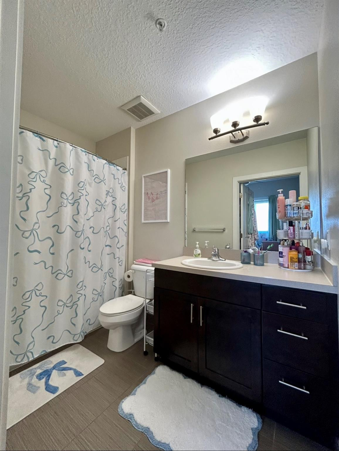 135 Northwest 20th Street, Unit E45B Boca Raton, FL 33431 - Photo 3 of 21 a spacious bathroom with a double vanity sink toilet and a mirror