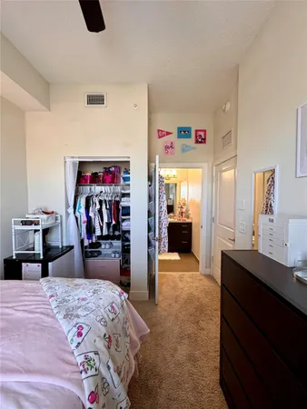 a bedroom with a bed and a large mirror