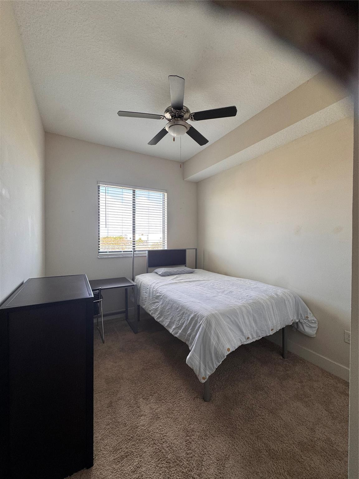 135 Northwest 20th Street, Unit E45B Boca Raton, FL 33431 - Photo 7 of 21 a spacious bedroom with a bed and a chandelier