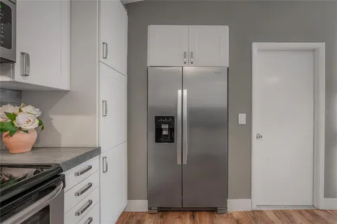 a kitchen with a refrigerator and a stove
