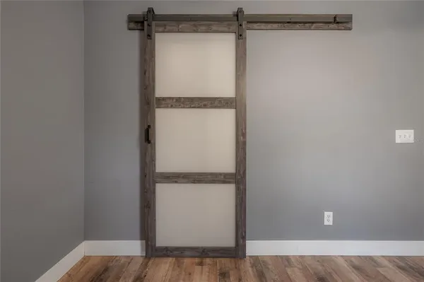 a view of a room with wooden floor