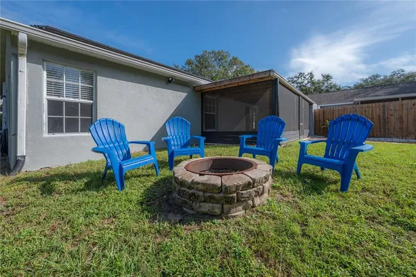 a view of an chairs in backyard of a house