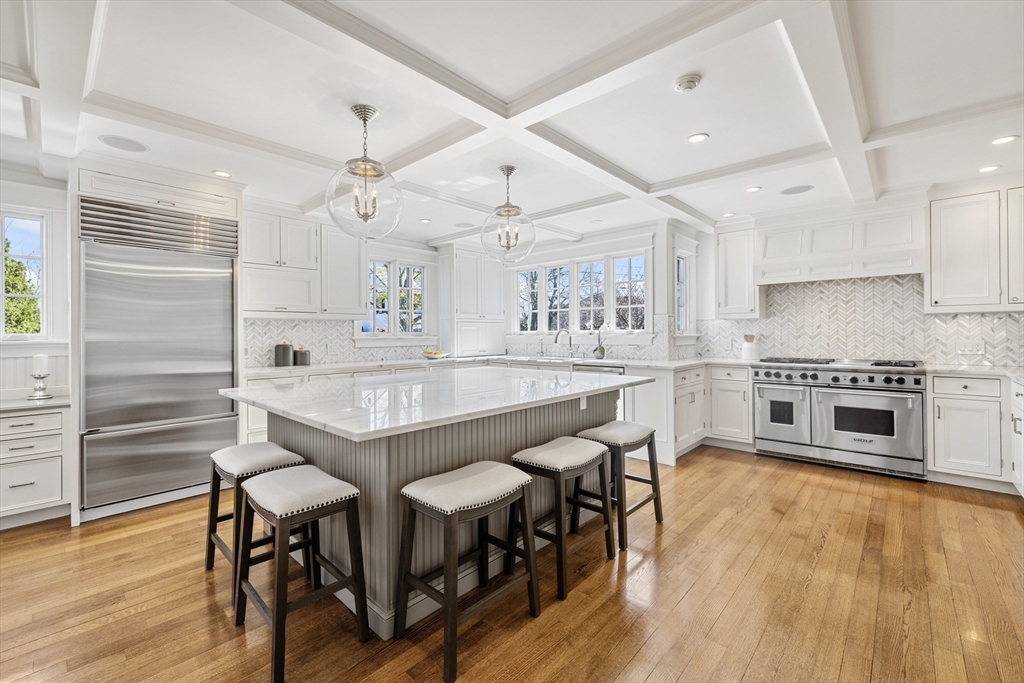 3 Goldthwait Road Marblehead, MA 01945 - Photo 6 of 30 a kitchen with stainless steel appliances a dining table chairs stove and wooden floor