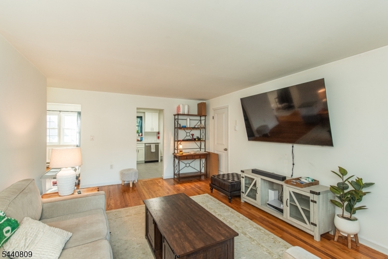 206 Main Street, Unit 42A Millburn, NJ 07041 - Photo 9 of 21 a living room with furniture and a flat screen tv