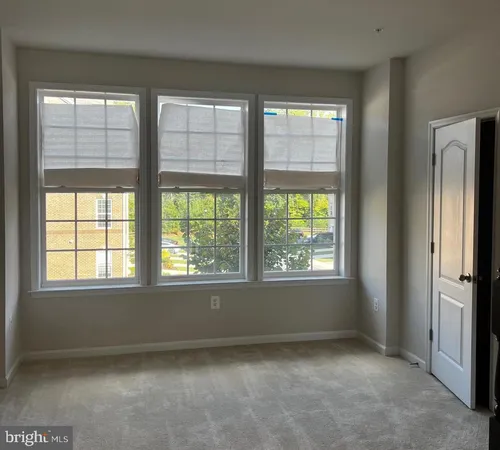 a view of entryway with furniture and wooden floor