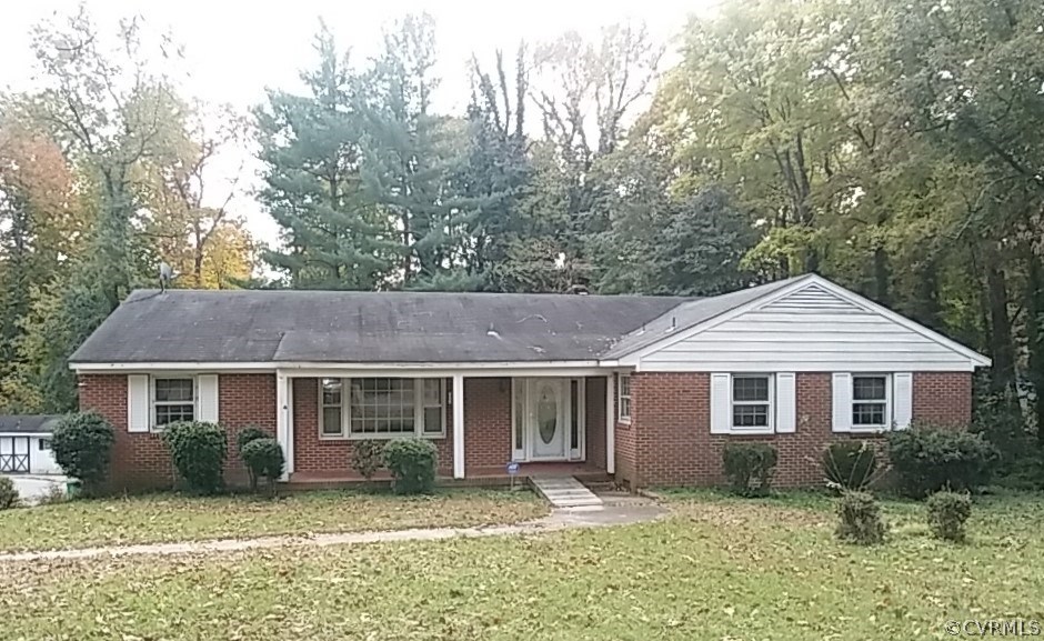 a front view of a house with yard and green space