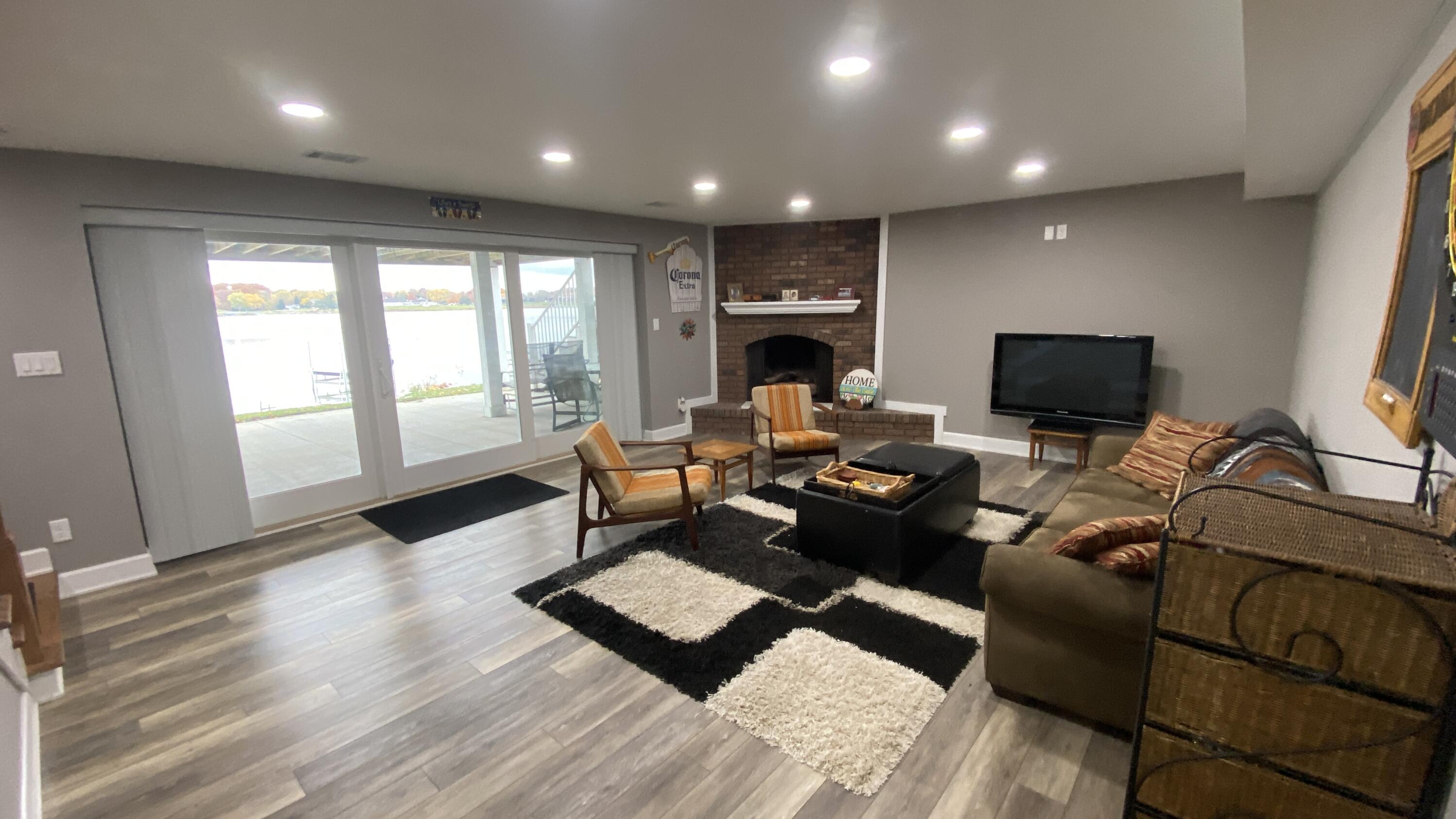 1728 Beachview Court Crown Point, IN 46307 - Photo 52 of 114 a living room with furniture a flat screen tv and a fireplace