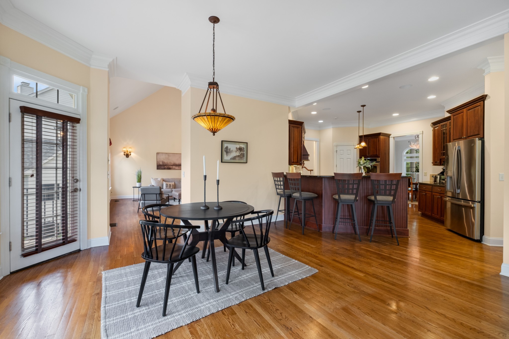 424 Sandcastle Road Franklin, TN 37069 - Photo 21 of 65 a view of a dining room and livingroom with furniture wooden floor a chandelier