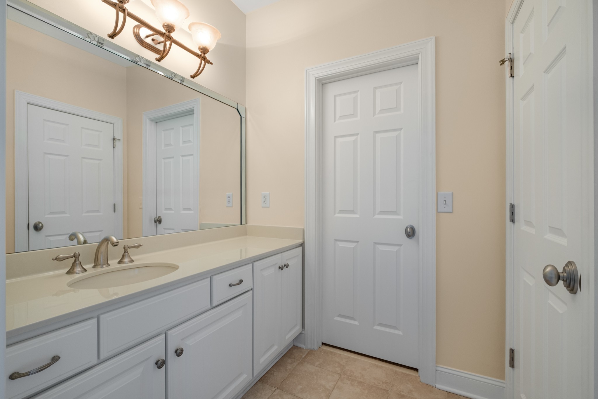 424 Sandcastle Road Franklin, TN 37069 - Photo 46 of 65 a bathroom with a sink a mirror and a shower