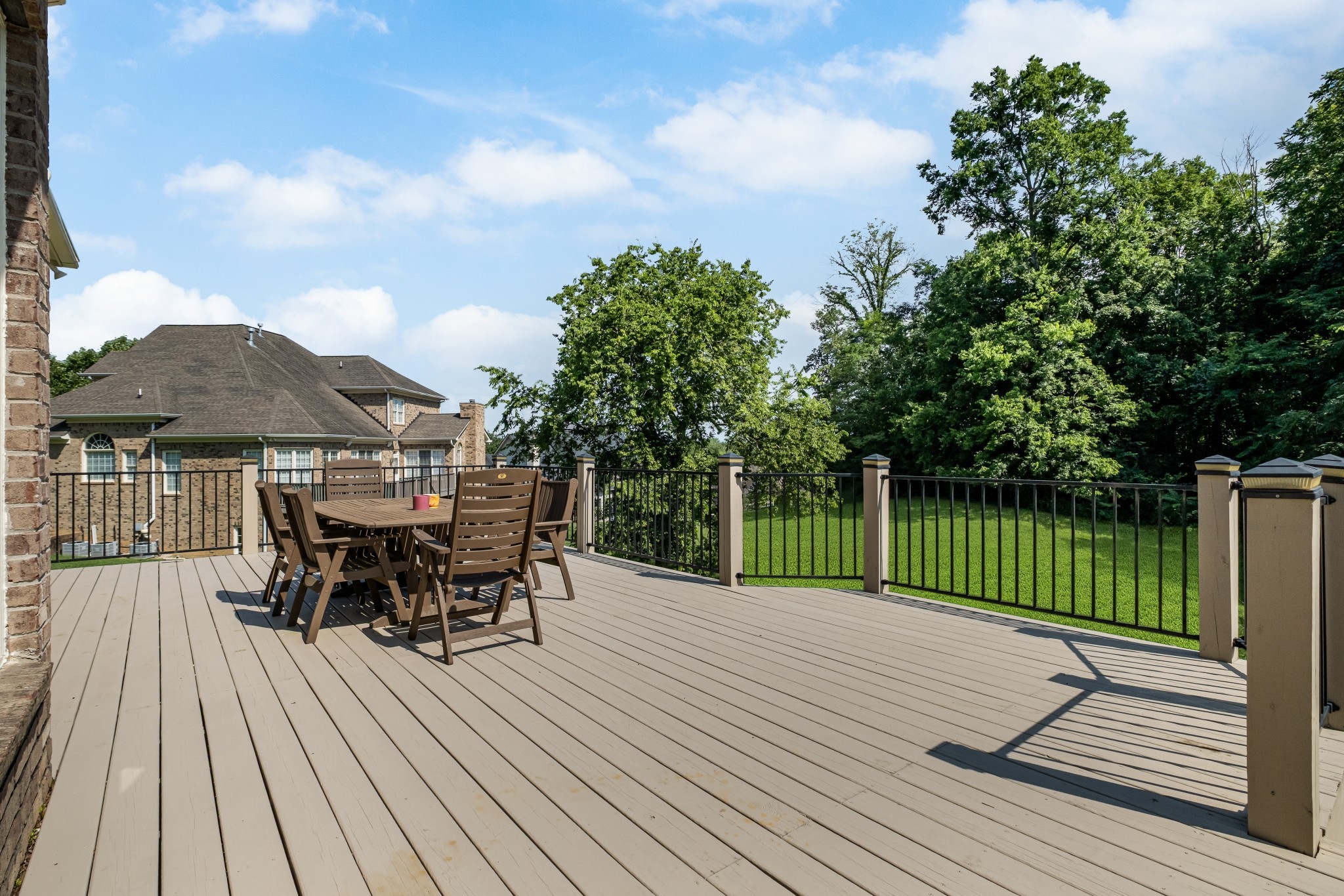 424 Sandcastle Road Franklin, TN 37069 - Photo 54 of 65 a view of a roof deck with table and chairs with wooden floor and fence