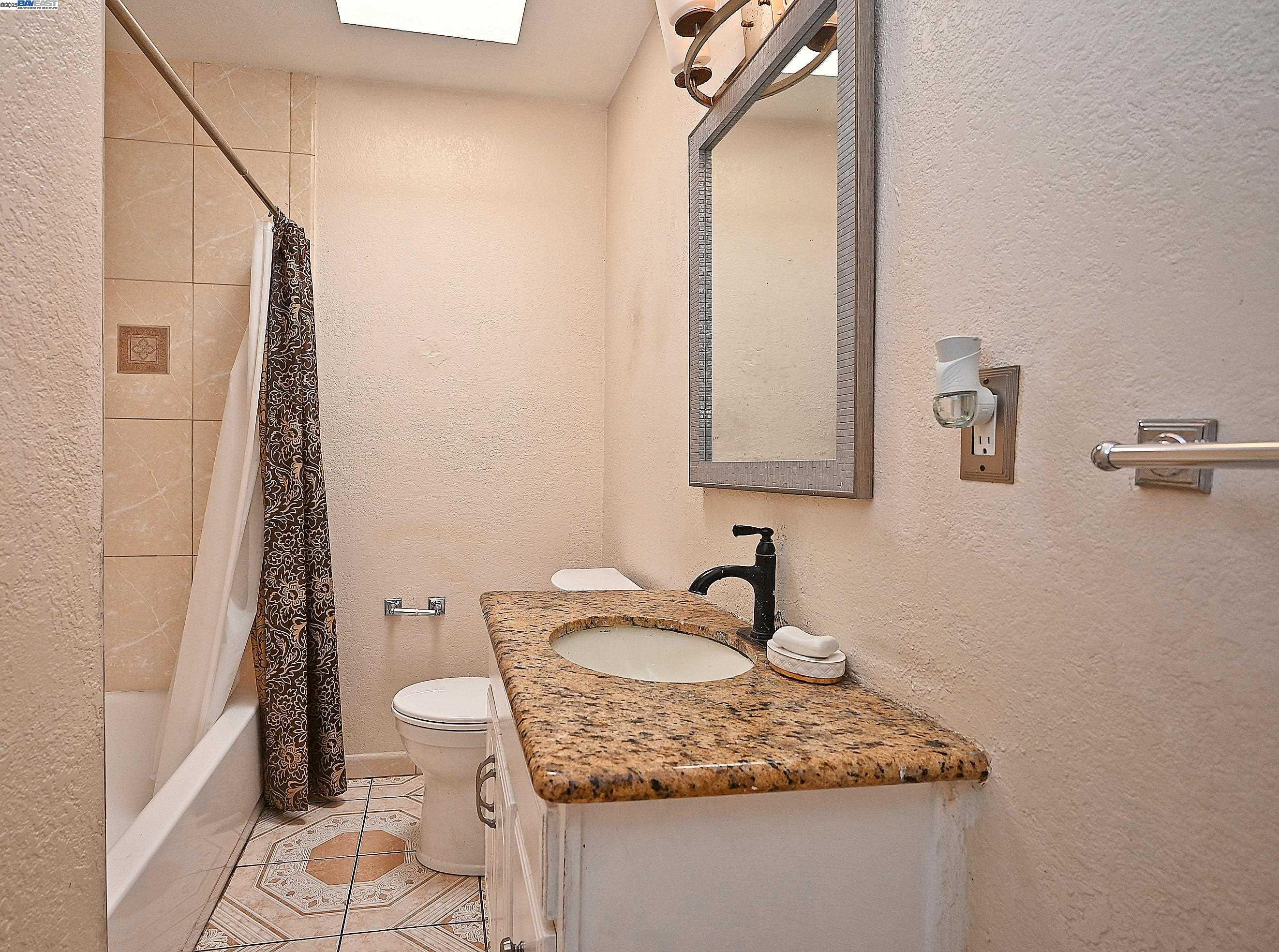 19092 Ricardo Avenue San Lorenzo, CA 94541 - Photo 14 of 29 a bathroom with a granite countertop sink and a mirror