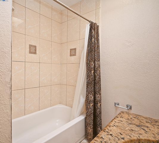a bathroom with a bathtub and shower