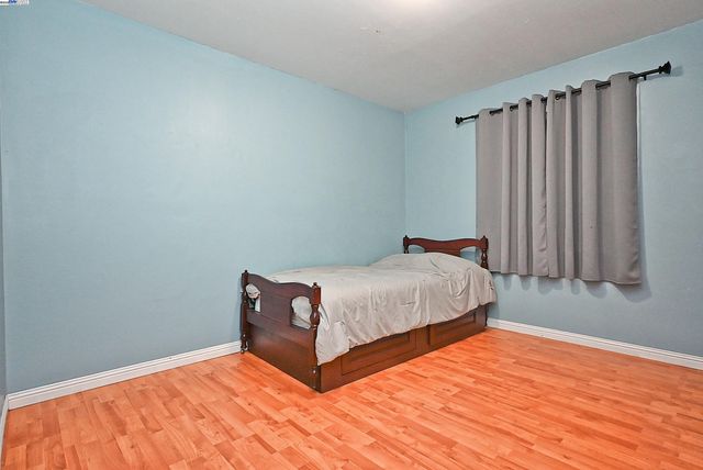 a bed sitting in a bedroom next to a window