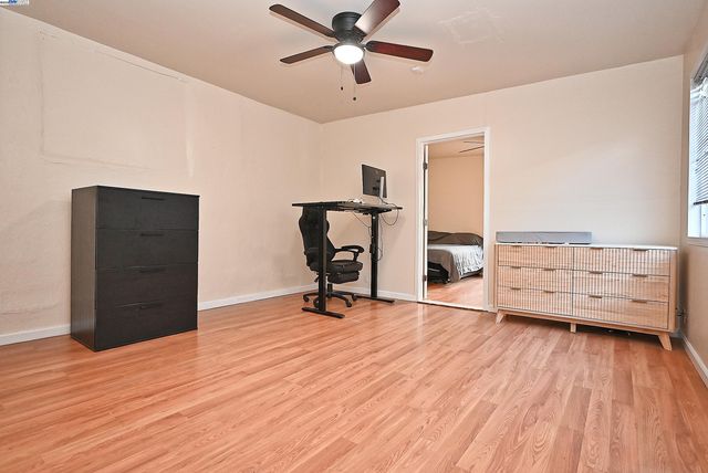 a view of a livingroom with furniture and a ceiling fan
