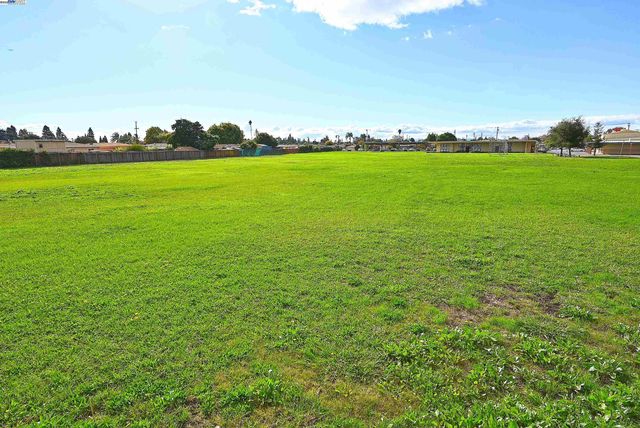 a view of a green field with clear sky