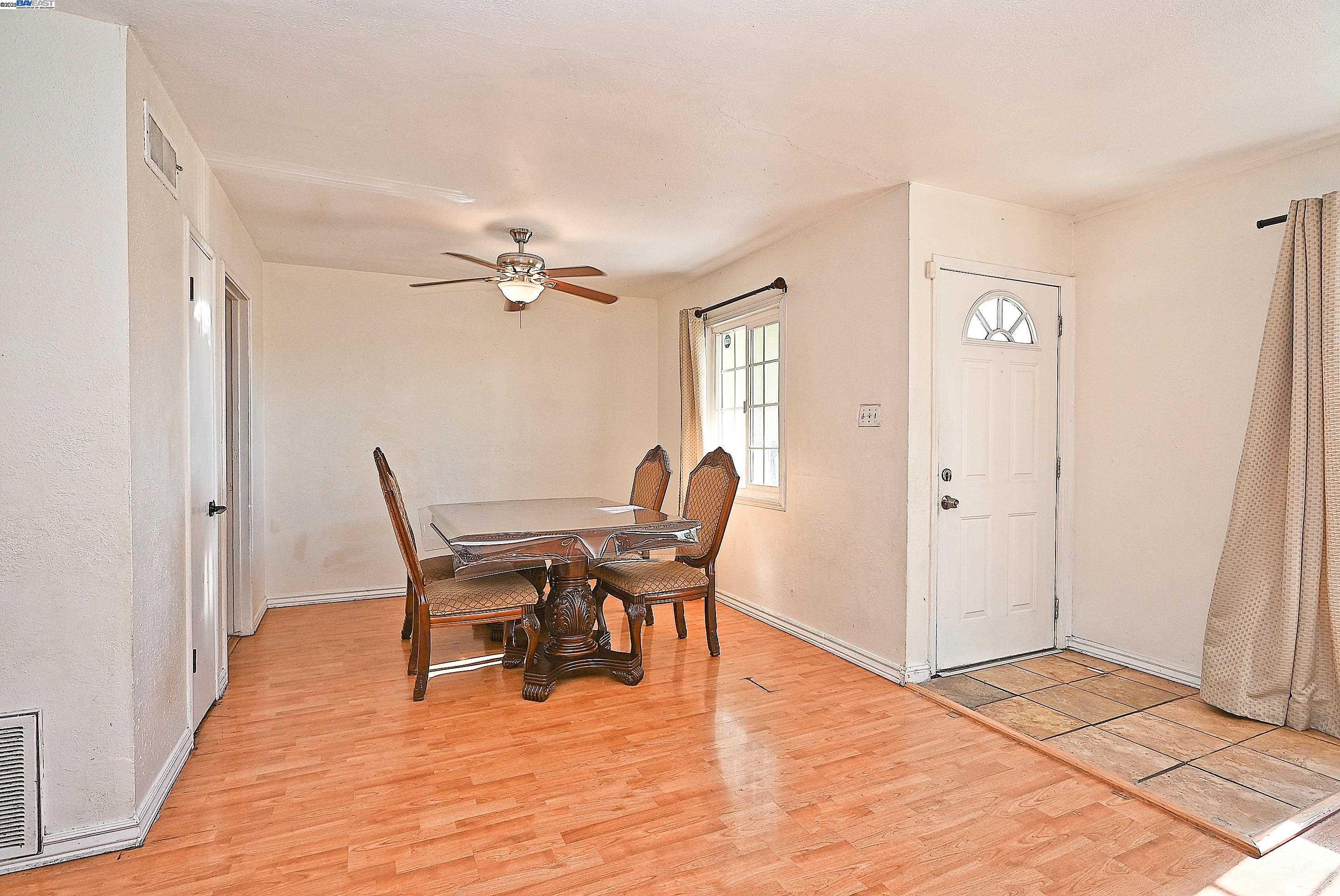 19092 Ricardo Avenue San Lorenzo, CA 94541 - Photo 9 of 29 a workspace with wooden floor and a chandelier fan