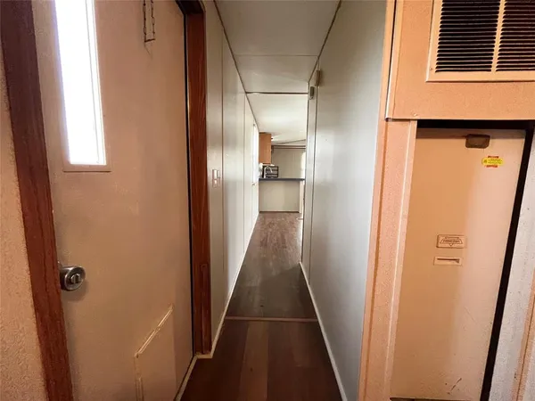 a view of a hallway with wooden floor