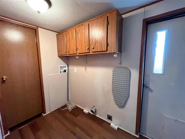 an entryway with wooden floor and windows