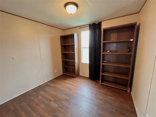 a view of an empty room with a closet