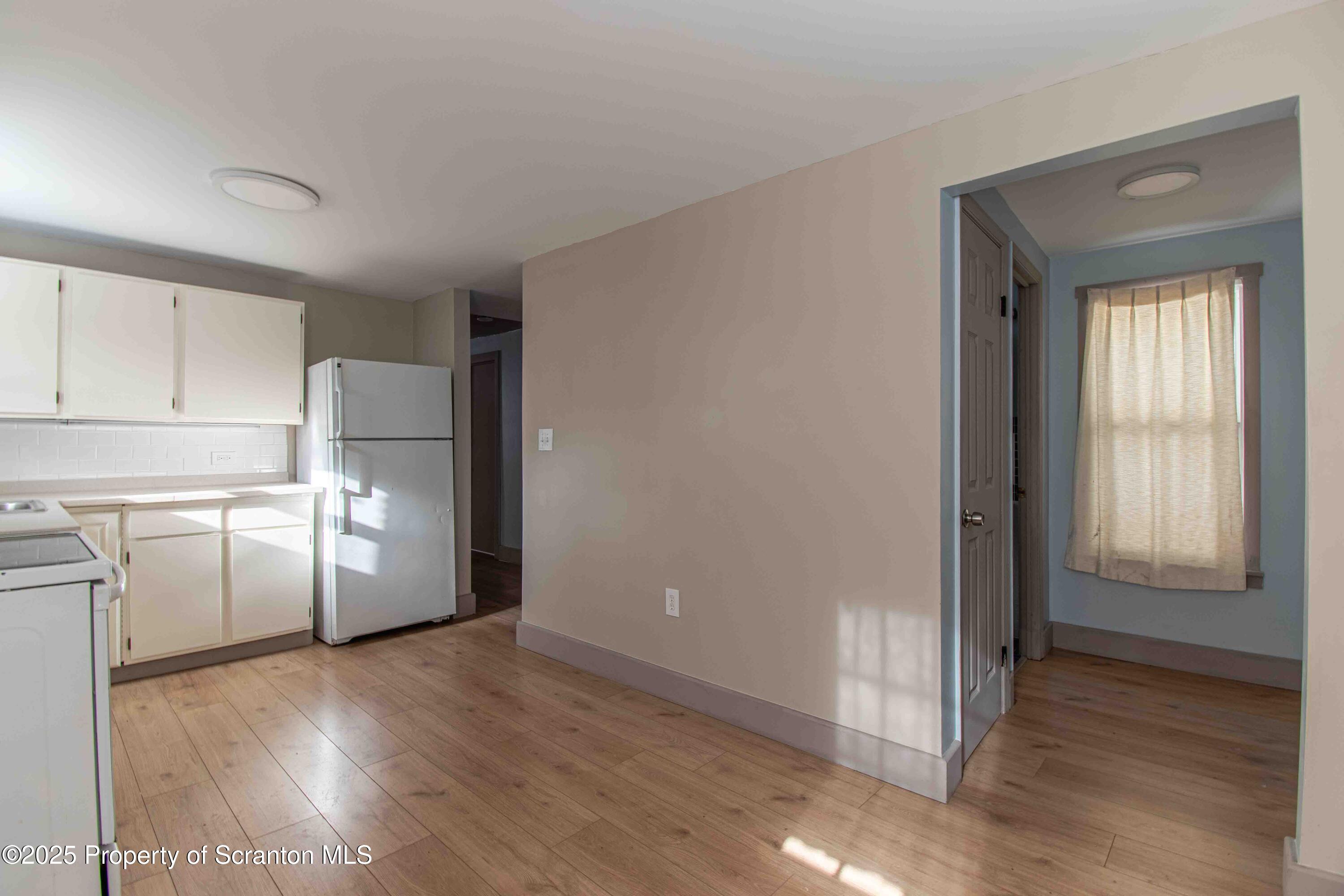 540 North Main Street Simpson, PA 18407 - Photo 4 of 17 a view of a kitchen with wooden floor and electronic appliances