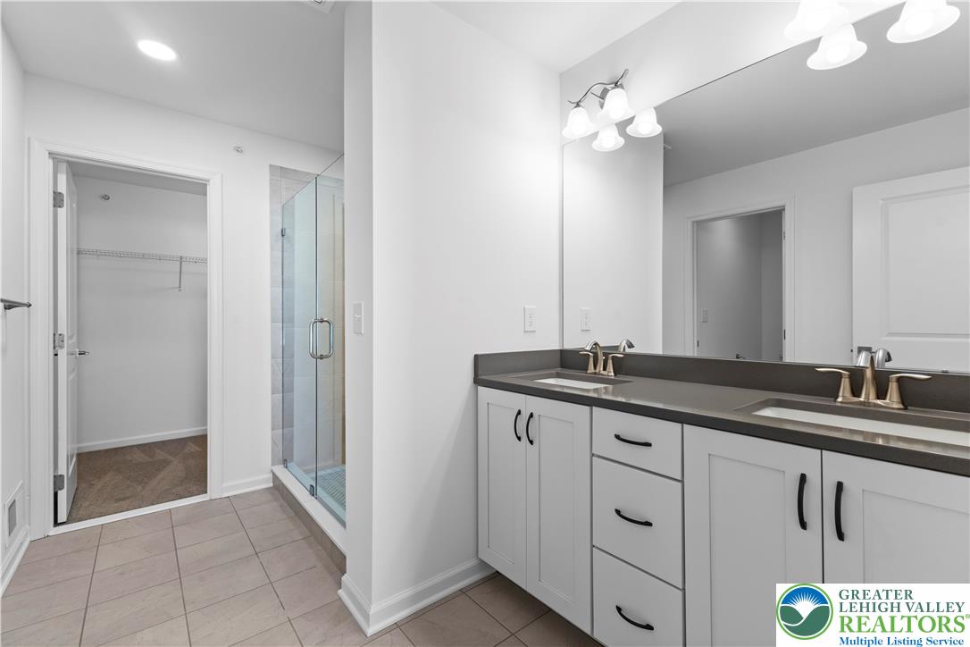 93 Timber Trail, Unit 46 Easton, PA 18045 - Photo 18 of 26 a bathroom with a granite countertop sink and a mirror