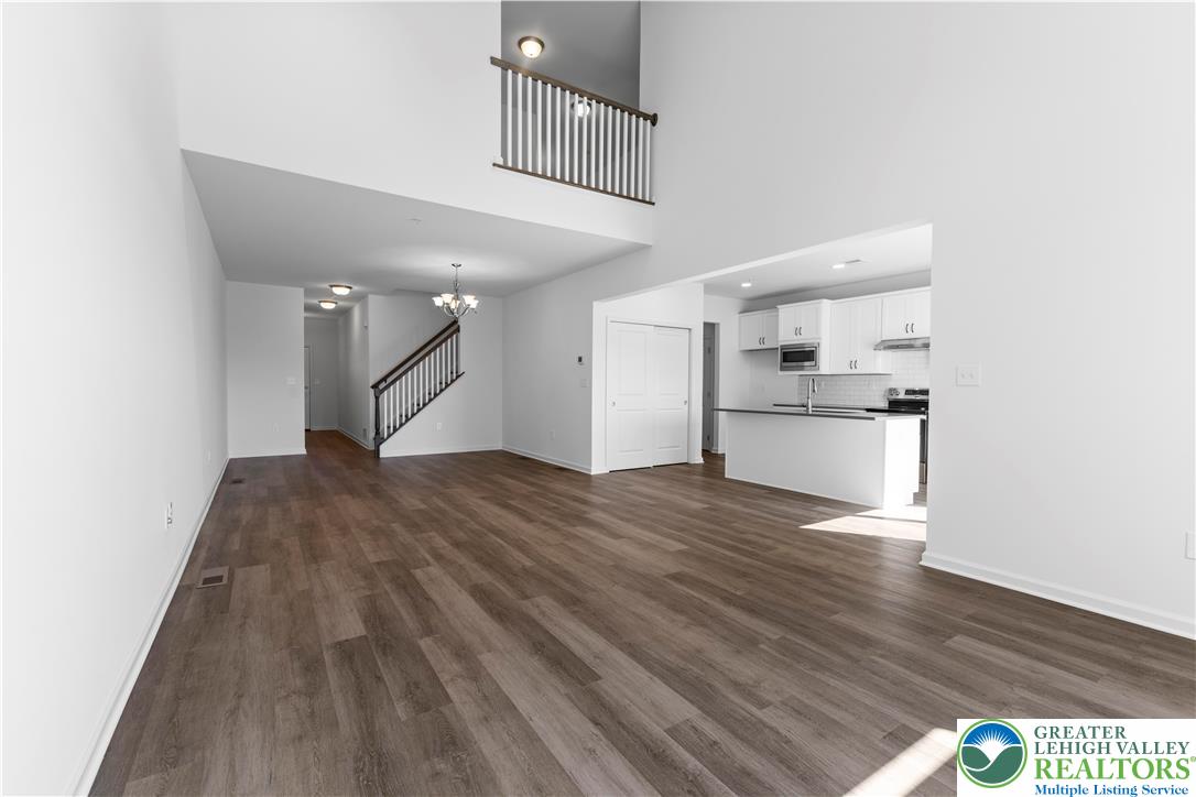 93 Timber Trail, Unit 46 Easton, PA 18045 - Photo 7 of 26 a view of a kitchen with wooden floor and a ceiling fan