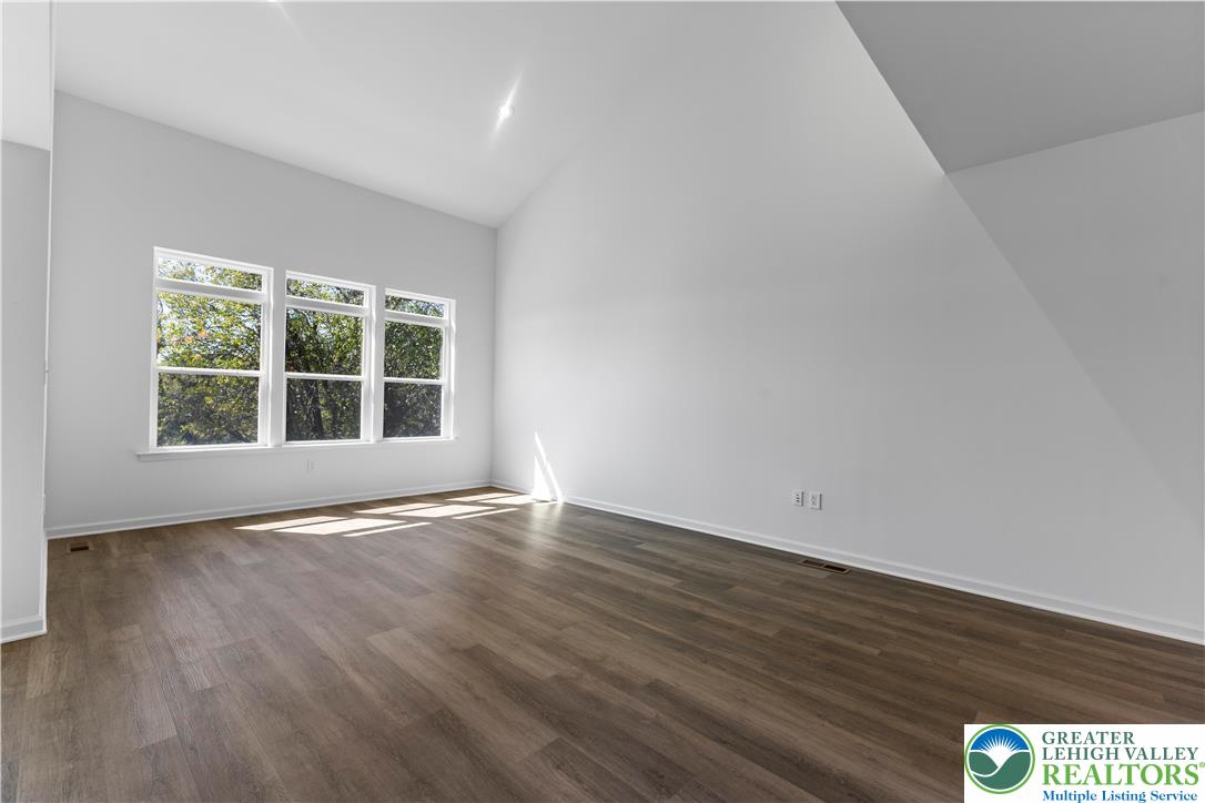 93 Timber Trail, Unit 46 Easton, PA 18045 - Photo 8 of 26 a view of an empty room with wooden floor and windows