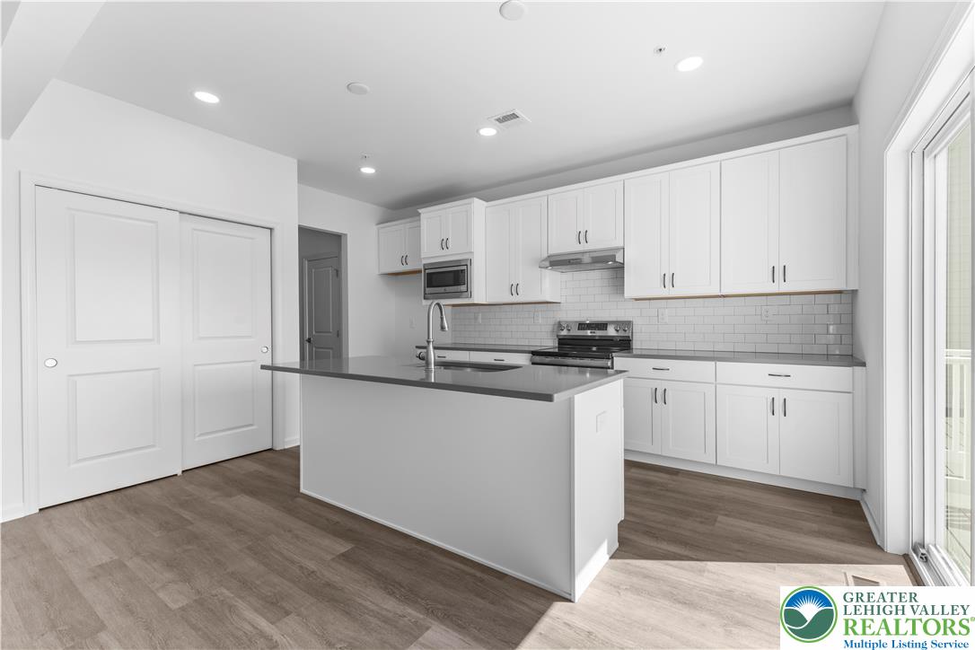 93 Timber Trail, Unit 46 Easton, PA 18045 - Photo 10 of 26 a kitchen with granite countertop white cabinets and white appliances