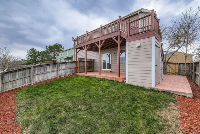 a view of a house with wooden fence