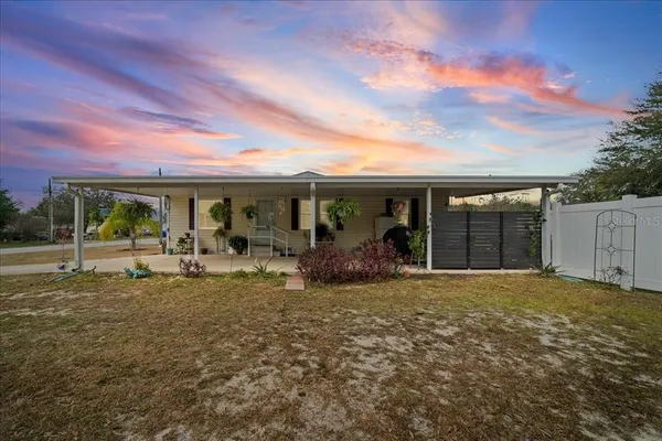 a view of a house with backyard porch and sitting area