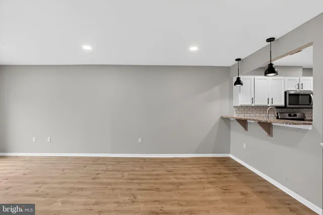 a kitchen with stainless steel appliances granite countertop a stove microwave and refrigerator