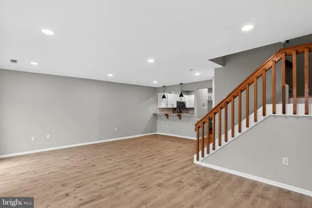 a view of an empty room with stairs and ventilation
