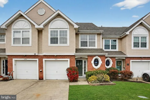 a view of a house with a yard and plants