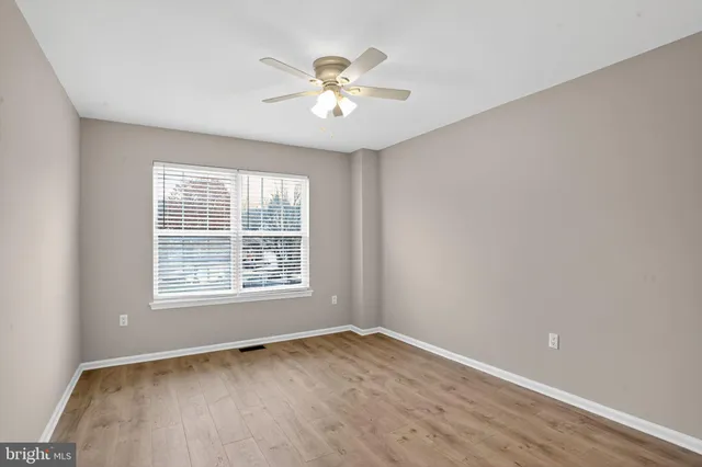 a view of an empty room and wooden floor